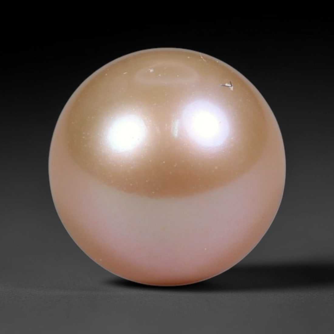 3.37ct Natural Round Freshwater Peach Pink Pearl Loose Gemstone 8.10mm, 45XA: Flawless natural undrilled round freshwater pearl, showcasing a smooth symmetrical spherical form with soft gradient peach blush nacre transitioning from warm apricot crown to pale pink base. The pear
