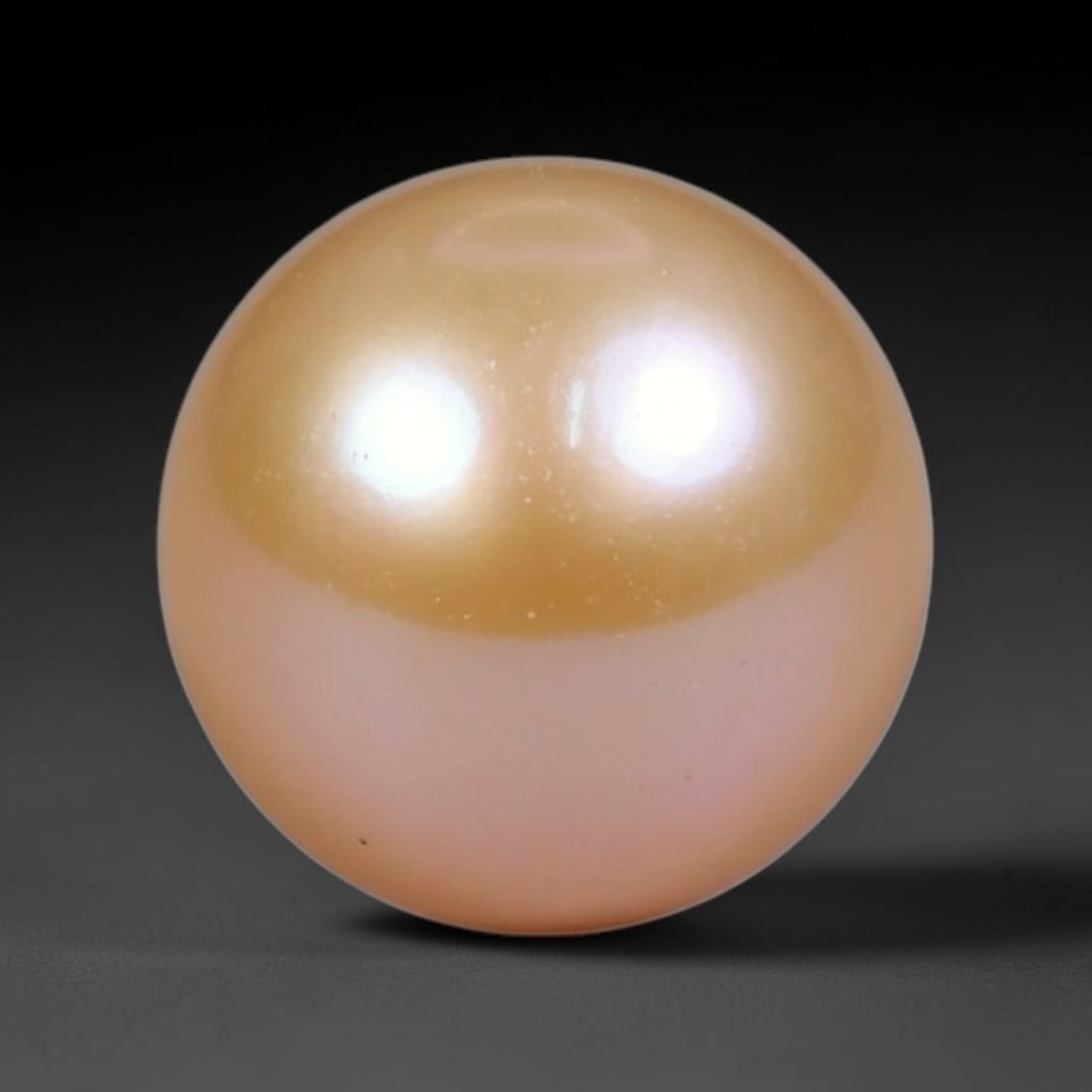 3.25ct Natural Round Freshwater Peach Pink Pearl Loose Gemstone 7.7mm, 45XZ: Flawless natural undrilled round freshwater pearl, showcasing a smooth symmetrical spherical form with soft gradient peach blush nacre transitioning from warm apricot crown to pale pink base. The pear