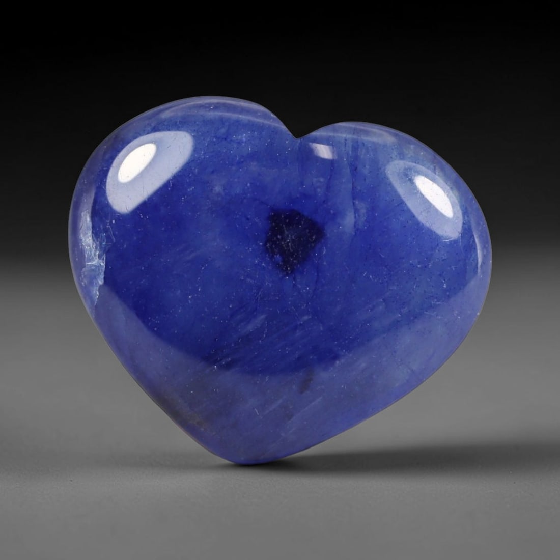 8.52 Carats Natural Madagascar Deep Royal Blue Heated Sapphire Heart Cabochon Loose Gemstone, 28WS: This rich deep royal blue sapphire cabochon holds soft blended navy-blue shades across its smoothly polished heart domed surface, featuring a distinct central dark mineral inclusion alongside fine nat