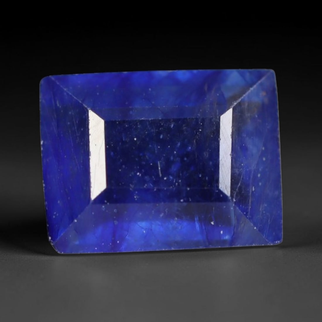 2.14 Carats Royal Blue Sapphire Emerald Cut Loose Gemstone, 42WS: This sharp emerald rectangular faceted sapphire features an intense deep royal blue hue, brought to vivid life by crisp step-cut facets. Natural fine fissures and scattered tiny mineral micro-inclusio