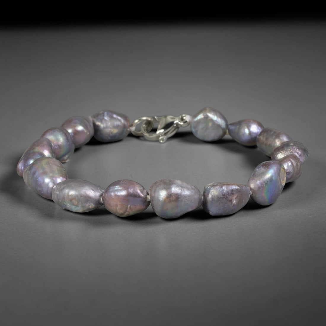 Natural Freshwater Pearl Bracelet - Baroque Dark Peacock Pearl Strand, 90YM: Strung from large organic baroque natural freshwater pearls displaying deep peacock iridescence with shifting violet, teal and bronze overtones, each bead retaining naturally irregular teardrop contou