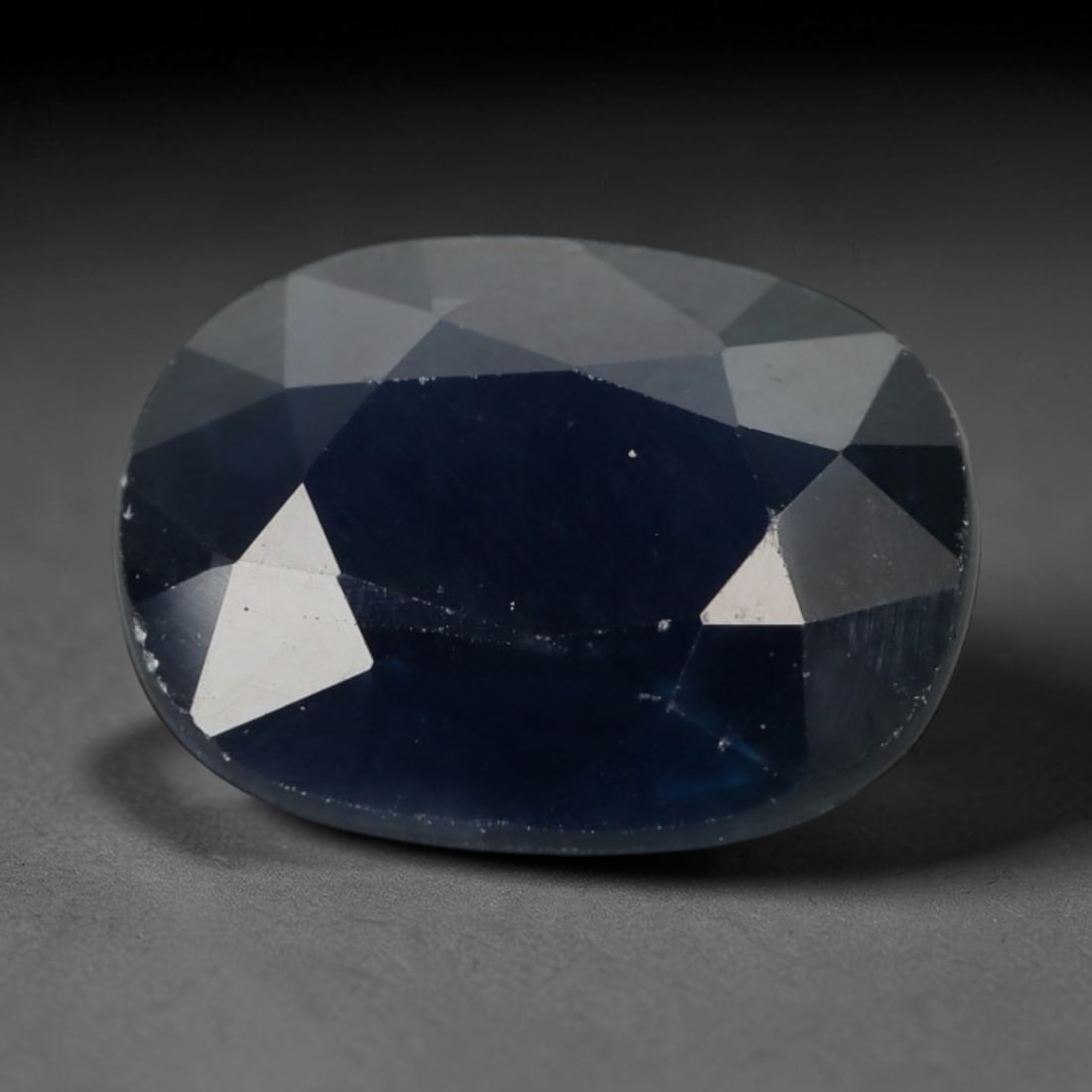2.23ct Natural Madagascar Deep Navy Blue Sapphire Oval Loose Faceted Gemstone, LZ295: This natural oval faceted sapphire originating from Madagascar weighs 2.23 carats with precise dimensions of 8.9x7.0x3.6mm. It features a rich, intense deep navy blue core tone that gradually fades to