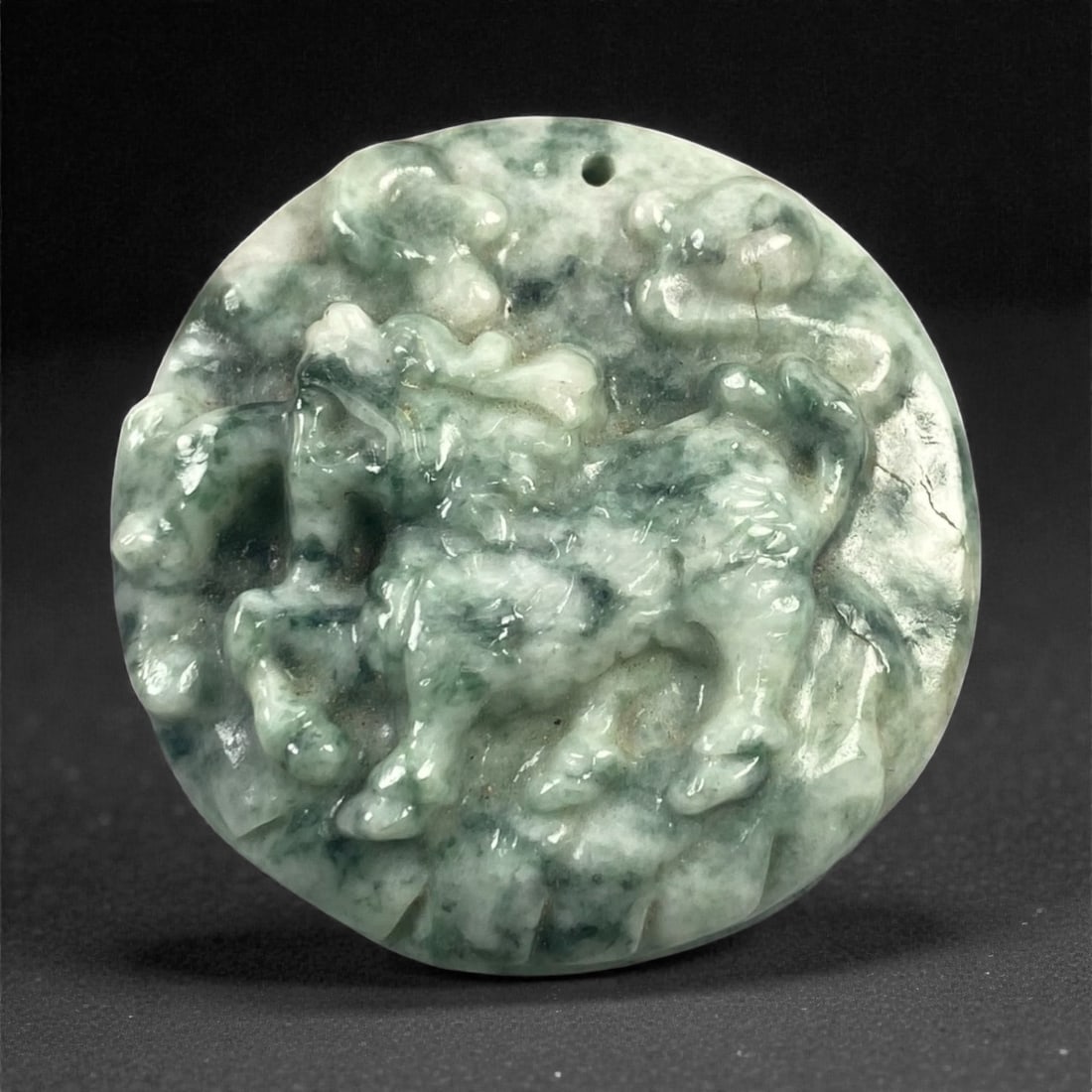Natural Type A Burmese Jadeite Jade Medallion Pendant, 61XC: Carved from mottled green and white jadeite with cloudy translucency and natural tonal variation, the medallion is circular in form and worked in low relief with a dynamic equine motif. The compositio