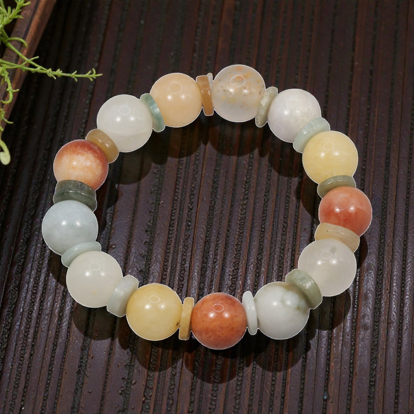 Natural Burmese Type A Jadeite Jade Multicolour Round Bead Bracelet, 40ZK: A carefully hand-strung bracelet made from polished spherical natural Burmese Type A jadeite round beads, individually separated by thin flat jadeite spacer discs. This bracelet showcases a rich natur