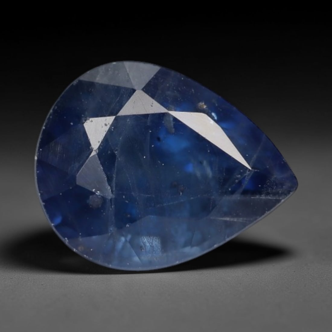 1.14ct Natural Muted Steel Blue Pear Shape Sapphire Loose Faceted Gemstone, LZ303: This natural pear faceted sapphire weighs 1.14 carats with precise dimensions of 6.9x5.4x3.9mm. It features a soft muted steel blue tone blended with translucent pale aqua undertones, showing natural 