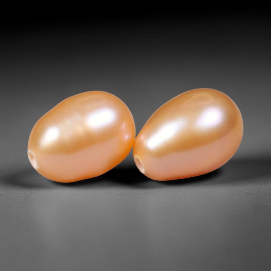 4.02ct Natural Peach Golden Orient Freshwater Egg Shape Pearl Pair, 61XZ: Matched pair of natural freshwater egg/oval pearls, uniform 8.3x6mm with clean through-drilled holes ready for jewelry setting. Each pearl features smooth silky nacre with a soft warm peach-gold base 