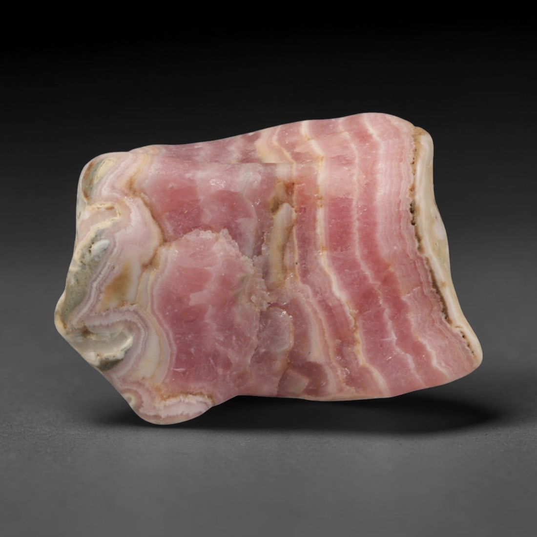 44ct Natural Argentine Rhodochrosite Tumbled Banded Rough Specimen, 97YQ: This smooth rounded rough specimen is natural banded rhodochrosite sourced from Argentina's Capillitas mining district, displaying characteristic layered concentric banding of soft blush pink, creamy 