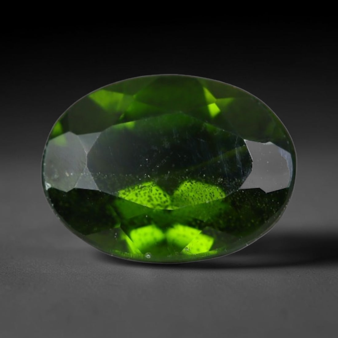 1.32 Carats Natural Vivid Chrome Green Chrome Diopside Oval Faceted Loose Gemstone, 44WS: This striking chrome diopside faceted oval stone showcases vivid intense chrome green color illuminated through crisp polished step facets, with fine tiny natural mineral speckles visible within the t