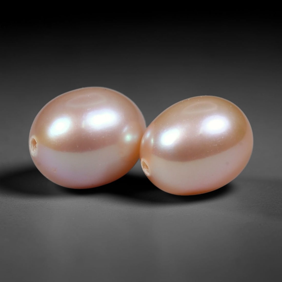 6.40ct Natural Soft Mauve Pink Orient Freshwater Egg Shape Pearl Pair, 65XZ: Matching pair of natural freshwater egg/oval pearls, uniform dimensions 9x7.3mm with neat fully drilled through holes ready for immediate jewelry assembly. Each pearl boasts a smooth satiny nacre surf