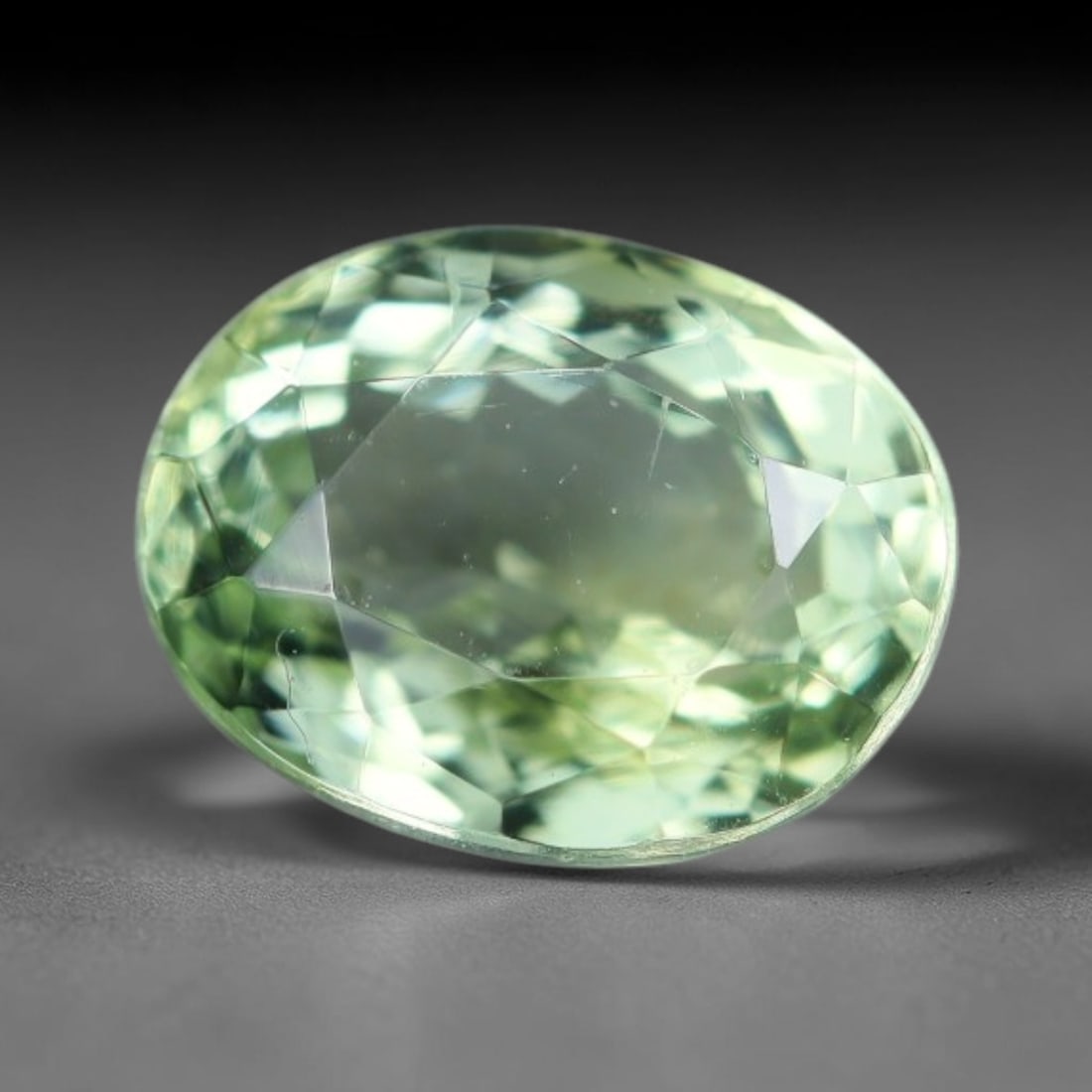 1.19 Carats Natural Pale Green Tourmaline Oval Faceted Loose Gemstone, 50WS: This elegant oval faceted tourmaline features soft pale mint green hue shining through crisp polished facets, with tiny subtle natural mineral specks scattered within its clear transparent crystal, me