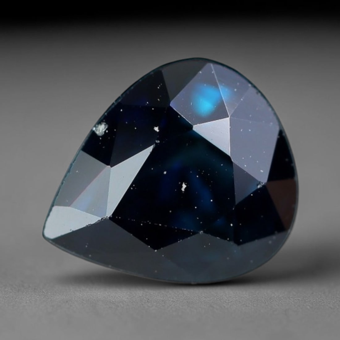 1.43 Carats Natural Deep Navy Pear Shape Sapphire Gemstone, 4XZ: I'm happy to present this nice single faceted sapphire cut into a tidy pear shape, rich with moody deep color all its own. This stone measures 7.0x6.0x4.5mm and weighs a solid 1.43 carats total. It ca