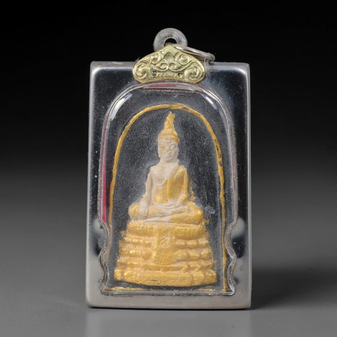 Thai Gilded Clay Metal Amulet Buddhist Votive Pendant, 46ZB: Crafted from fired clay with layered gilded surface finishes, the piece uses traditional molded production techniques common to Southeast Asian devotional craftwork. Its rectangular silhouette follows
