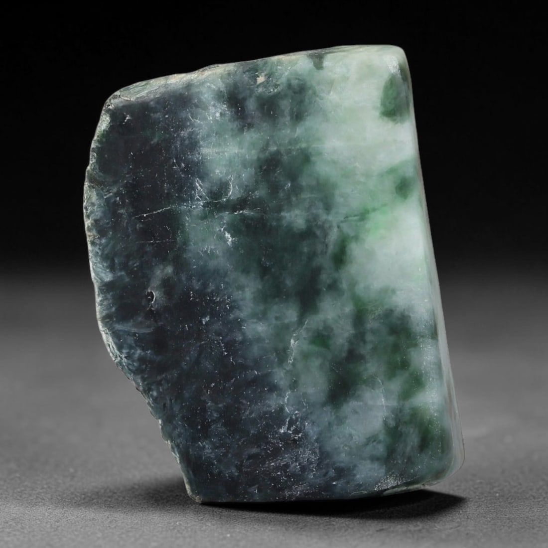232ct Natural Type A Burmese Jadeite Jade Sliced Rough, 28YR: This specimen is a sliced rough block of natural Type A Burmese jadeite jade. The interior displays natural colour zoning with visible mineral veining and crystalline patterns typical of unprocessed j