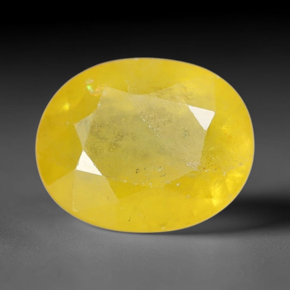 3.73 Carats Natural Yellow Sapphire Oval Faceted Loose Gemstone, 58XM: This natural yellow sapphire features a classic oval brilliant faceted cut, holding consistent warm golden-yellow color throughout the corundum crystal. Fine microscopic mineral specks and faint natur