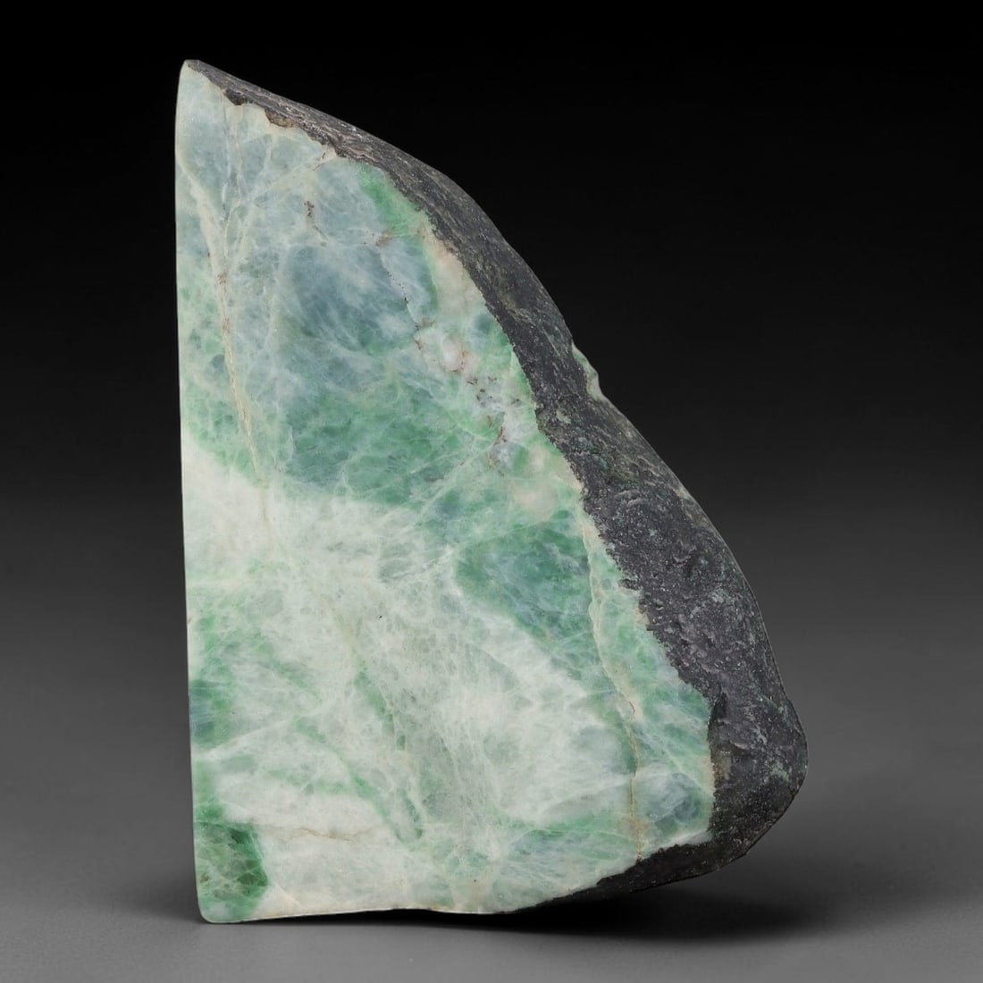 171ct Natural Type A Burmese Jadeite Jade Sliced Rough, 86YN: This specimen is a sliced rough block of natural Type A Burmese jadeite jade. The interior displays natural colour zoning with visible mineral veining and crystalline patterns typical of unprocessed j