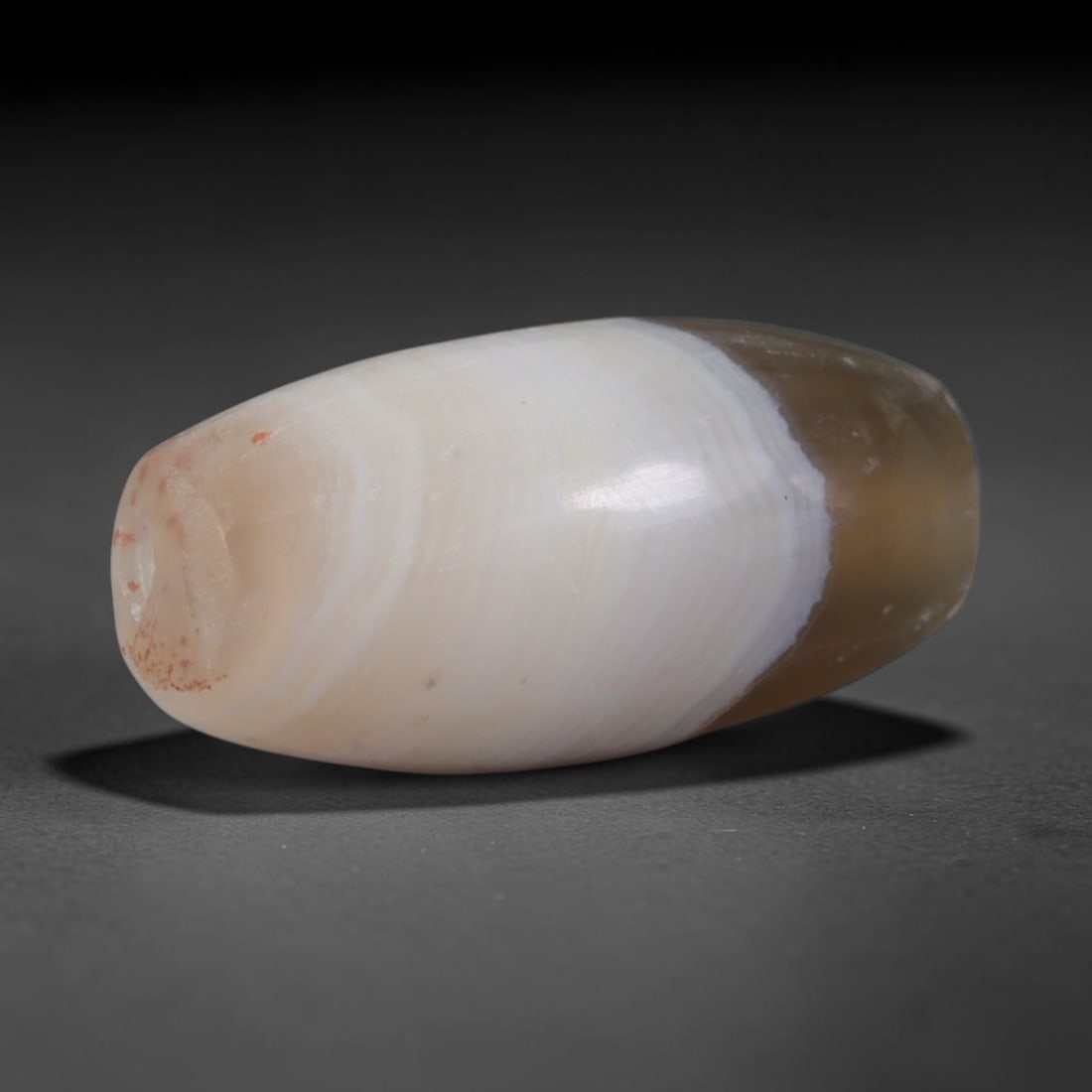 Ancient Sasanian Persian Empire Banded Agate Barrel Bead (224-651 CE), 83XD: This antique banded agate barrel bead originates from the Sasanian Persian Empire, a late antique West Asian civilization famed for crafting banded agate talismans for Zoroastrian ritual use and elite