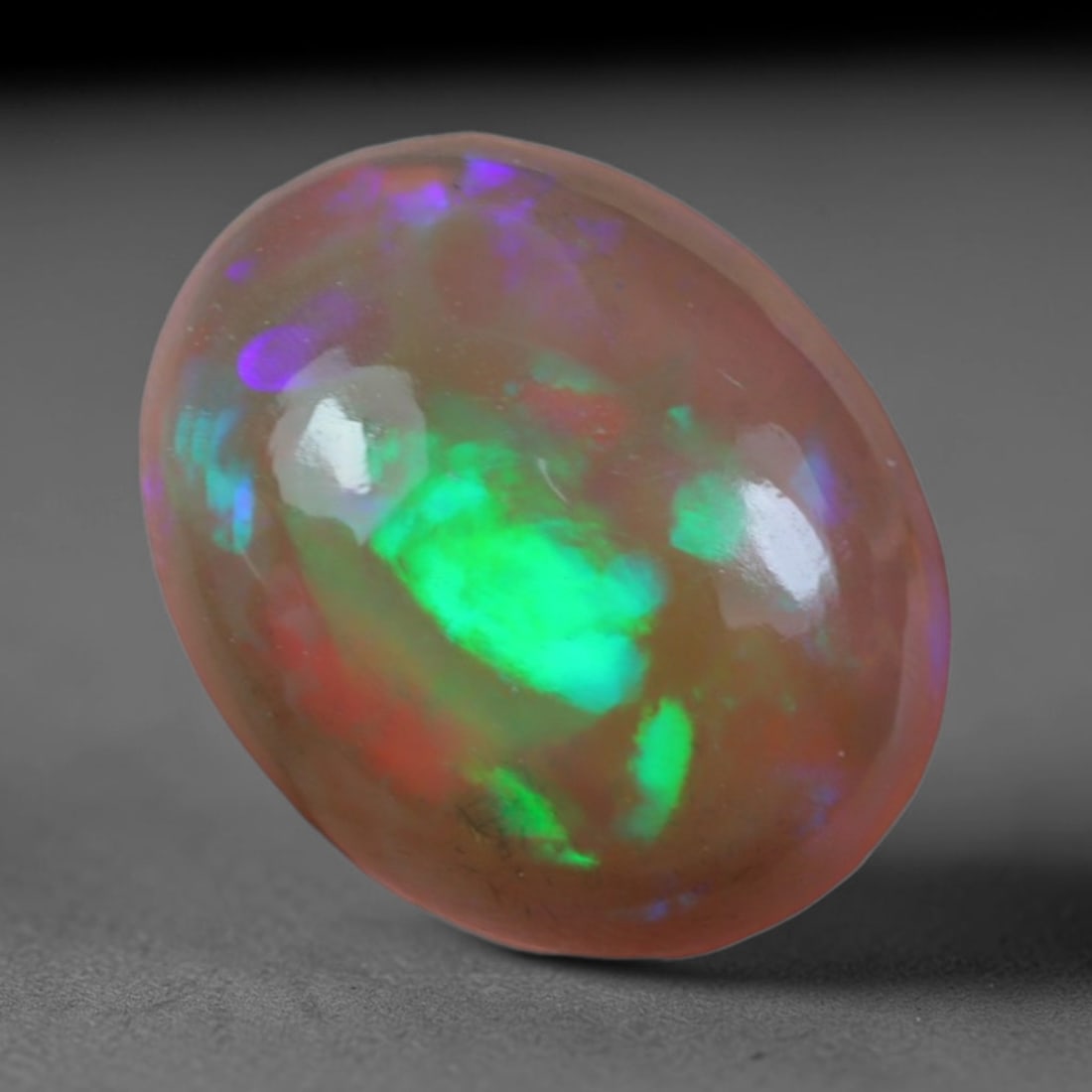 2.12 Carats Natural Ethiopian Welo Opal Oval Cabochon Loose Gemstone, 45XV: Natural Ethiopian Welo opal polished oval cabochon loose gemstone, luminous translucent milky white base stone with vivid multi-hued play-of-color featuring bright emerald green, lime yellow, soft blu