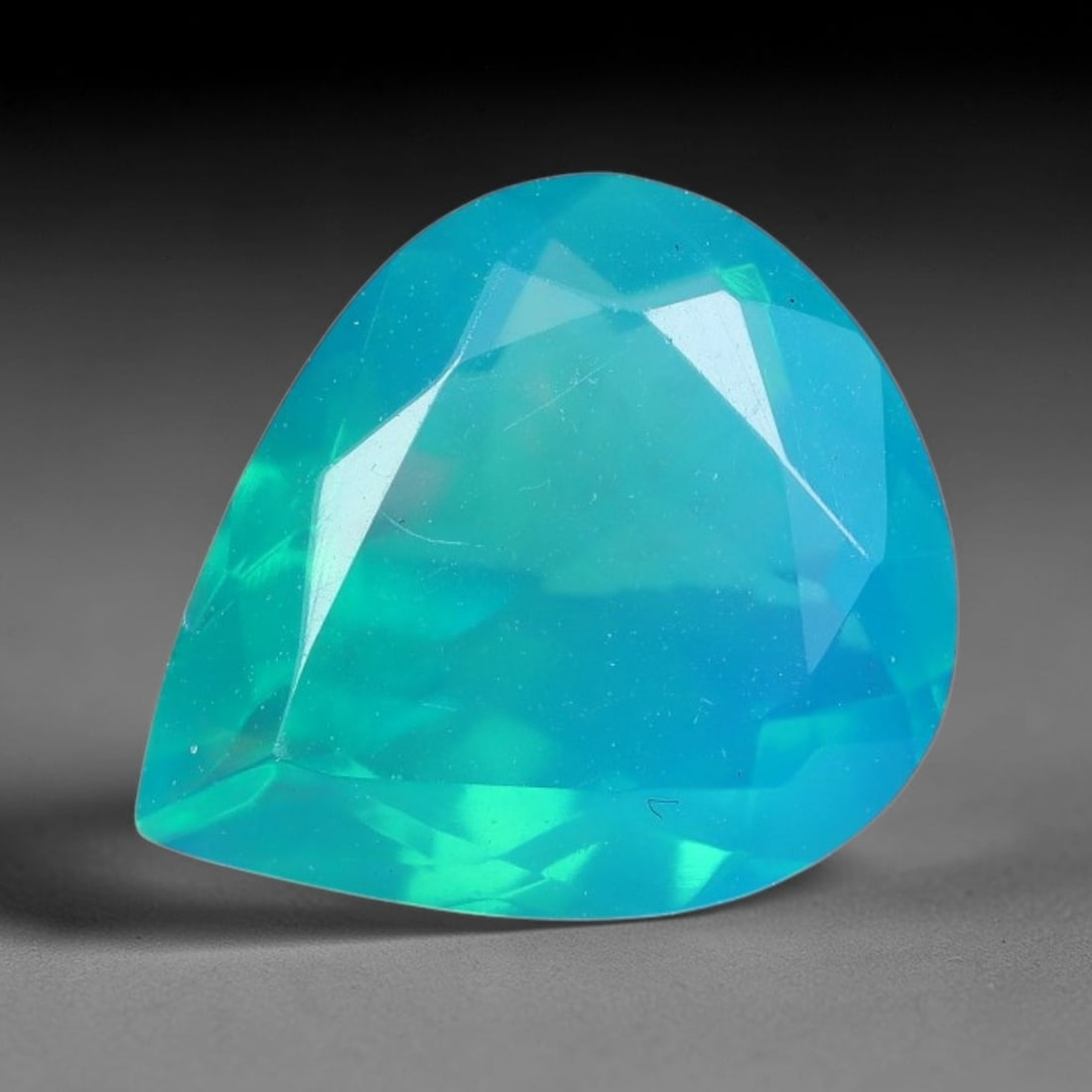 2.16 Carats Natural Ethiopian Welo Greenish Blue Fire Opal Pear Faceted Loose Gemstone, 70XX: This opal material is sourced from the Welo opal fields of Ethiopia and shaped into a pear faceted cut with professionally polished facets across the entire exterior surface. Faint natural internal fe