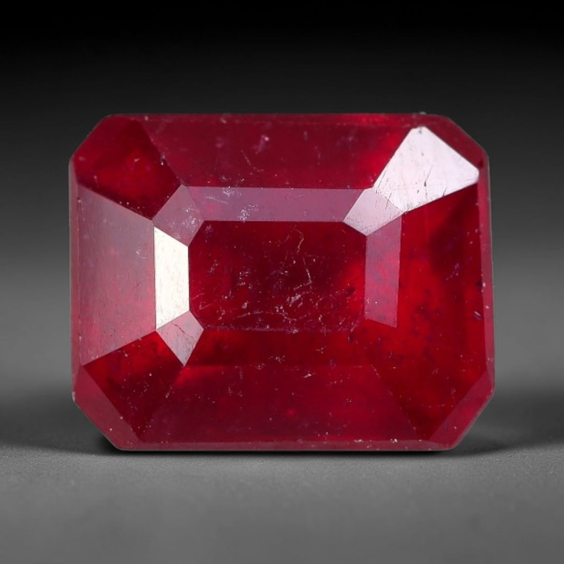 3.51 Carats Natural Madagascar Ruby Emerald Cut Loose Gemstone, 82XM: This natural Madagascar ruby is fashioned in a traditional emerald step faceted cut, showcasing deep saturated red tones typical of Malagasy corundum. Distinct natural internal fissures, fine mineral 