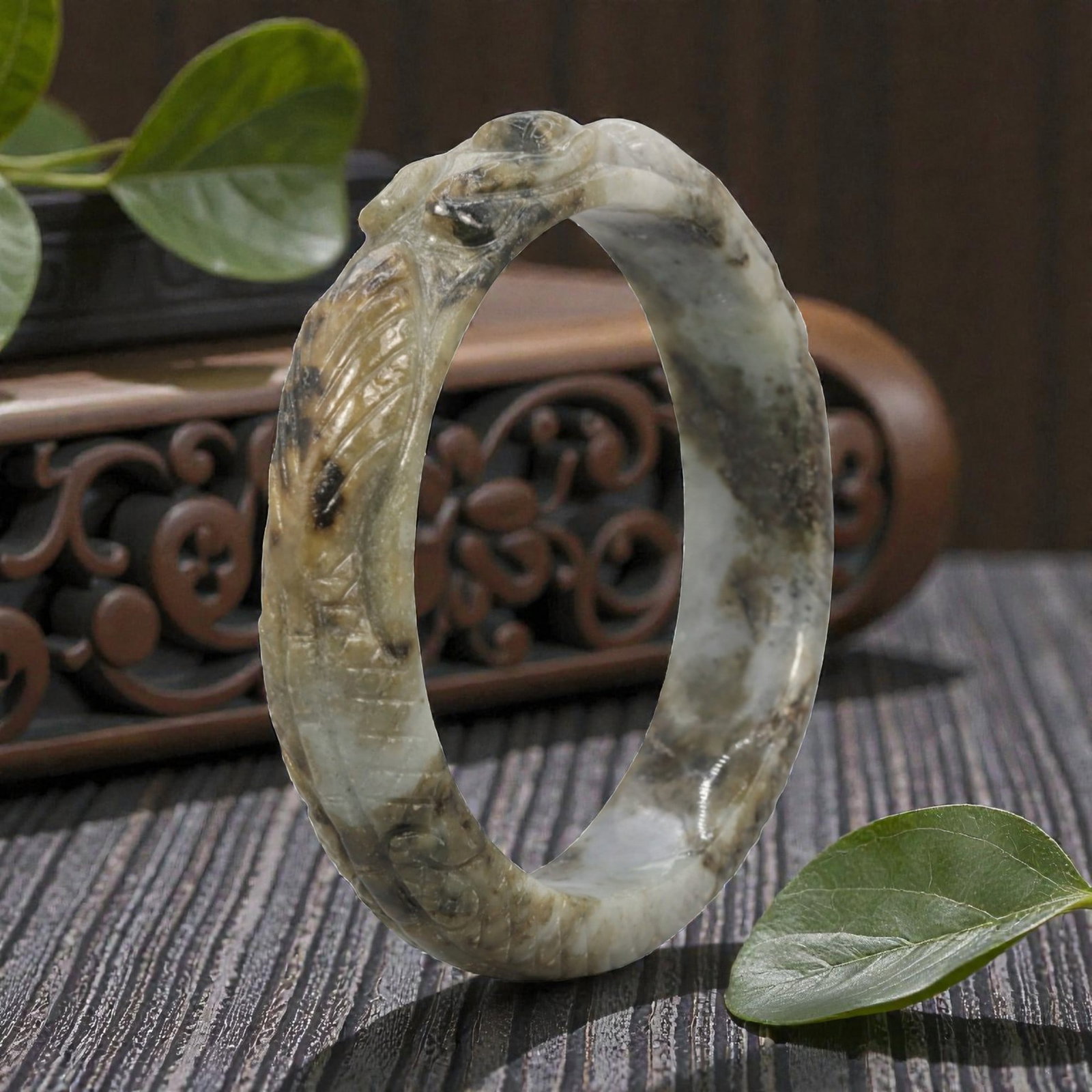 Natural Burmese Type A Carved Jadeite Jade Bangle Bracelet, 20th Century, 70ZL: A fine jadeite bangle of circular form, masterfully carved in relief with a continuous band of a sinuous dragon coiling around its circumference. The stone exhibits a striking variegated palette, with