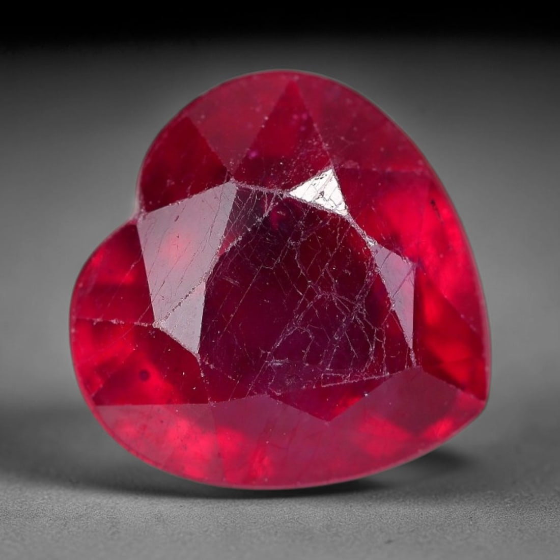 5.44 Carats Natural Madagascar Ruby Heart Faceted Loose Gemstone, 33XM: This natural Madagascar ruby is precision cut into a romantic heart brilliant faceted shape, bearing rich saturated crimson red tone typical of Malagasy corundum deposits. Extensive natural internal s