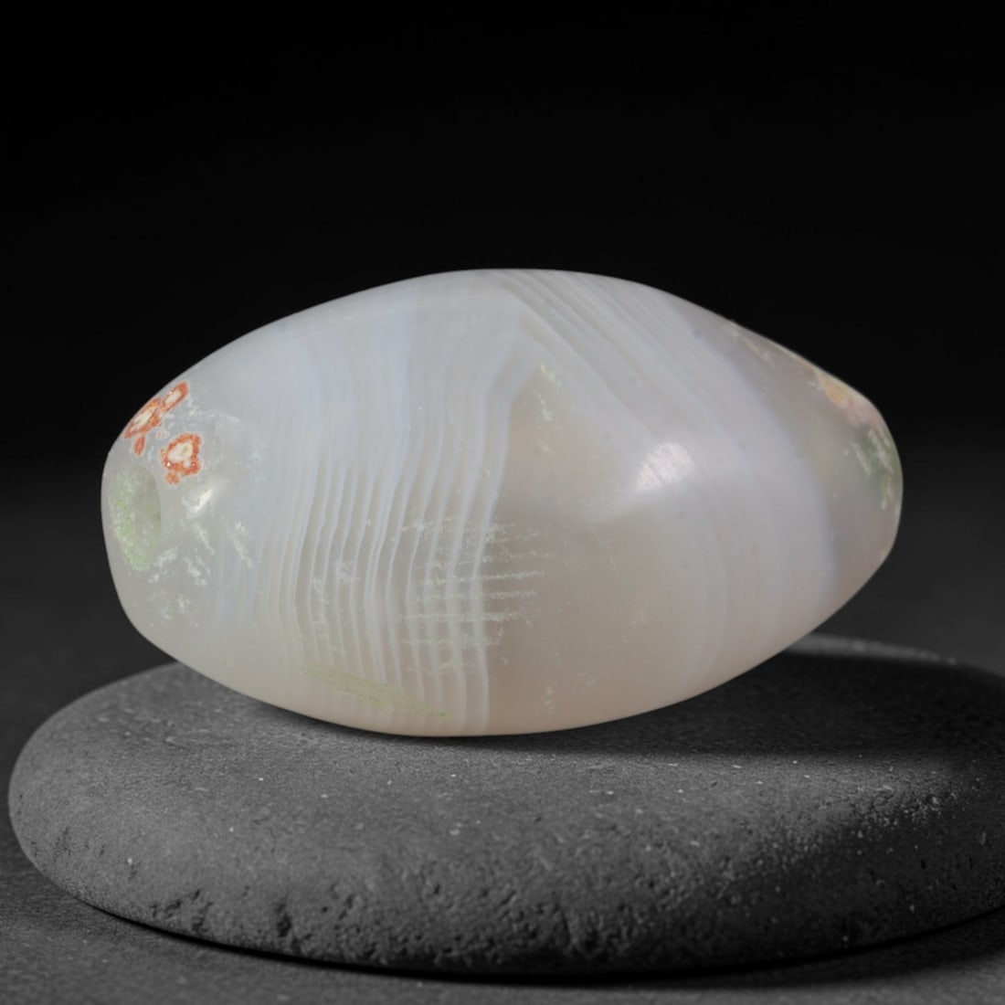 Ancient Minoan Civilization Banded Agate Bullet Bead (2700-1450 BCE), 56XD: This antique bullet-shaped banded agate bead originates from Minoan Civilization, the Bronze Age Cretan Aegean culture that sourced and refined chalcedony beads for palace burial jewelry and elite rit