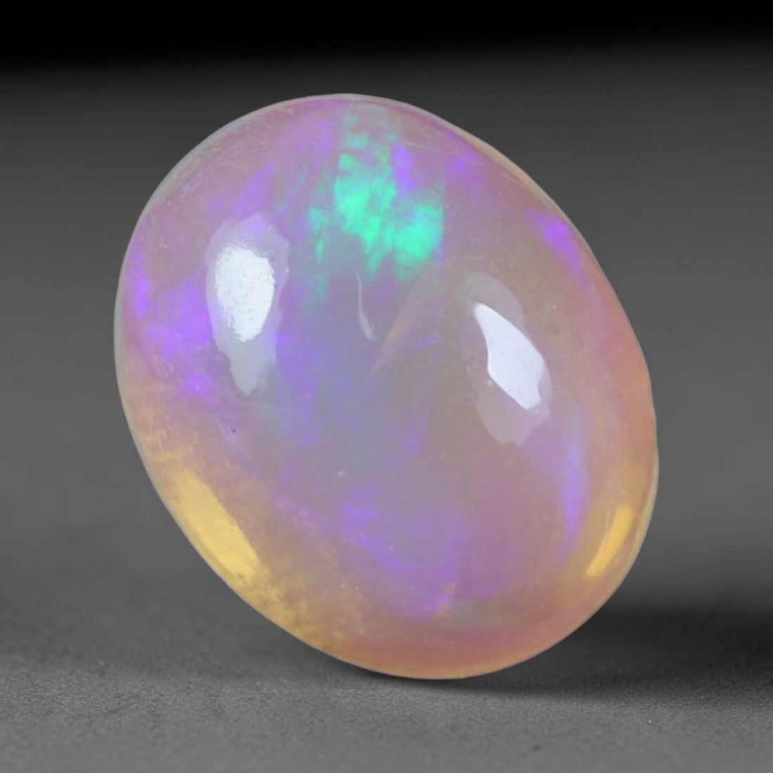 2.01 Carats Natural Ethiopian Welo Opal Oval Cabochon Loose Gemstone, 53XV: Natural Ethiopian Welo opal polished oval cabochon loose gemstone, luminous translucent milky white base stone with vivid multi-hued play-of-color featuring bright emerald green, lime yellow, soft blu