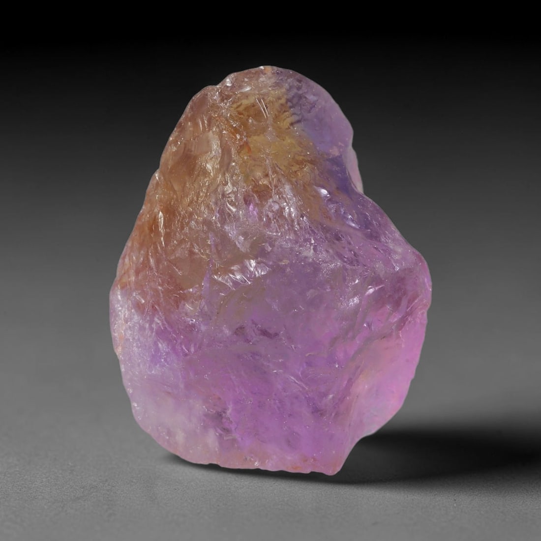 84.75 Carats Natural Bi-Color Ametrine Raw Rough Crystal Chunk, 75YR: This genuine natural ametrine rough showcases a seamless blend of soft lavender amethyst and pale golden citrine hues formed within a single quartz crystal. Delicate rusty orange mineral inclusions an