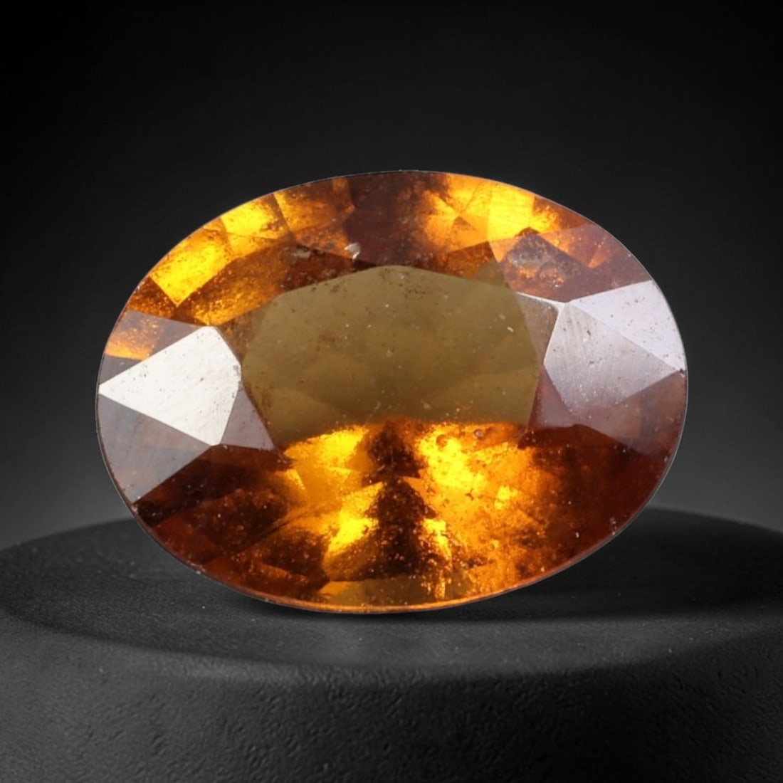 1.70 Carats Golden Orange Hessonite Garnet Oval - Natural Sri Lankan Stone, 69WW: This singular oval-cut hessonite garnet, measuring 9.1 x 7.0 x 3.9 mm, glows with a rich, honeyed golden-orange hue reminiscent of sunlit amber and warm cinnamon. Its faceting captures light to reveal