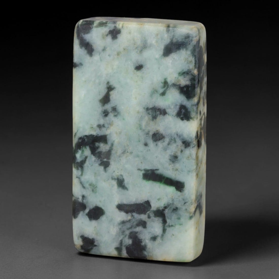 325ct Natural Type A Burmese Jadeite Jade Sliced Rough, 50YK: This specimen is a sliced rough block of natural Type A Burmese jadeite jade. The interior displays natural colour zoning with visible mineral veining and crystalline patterns typical of unprocessed j