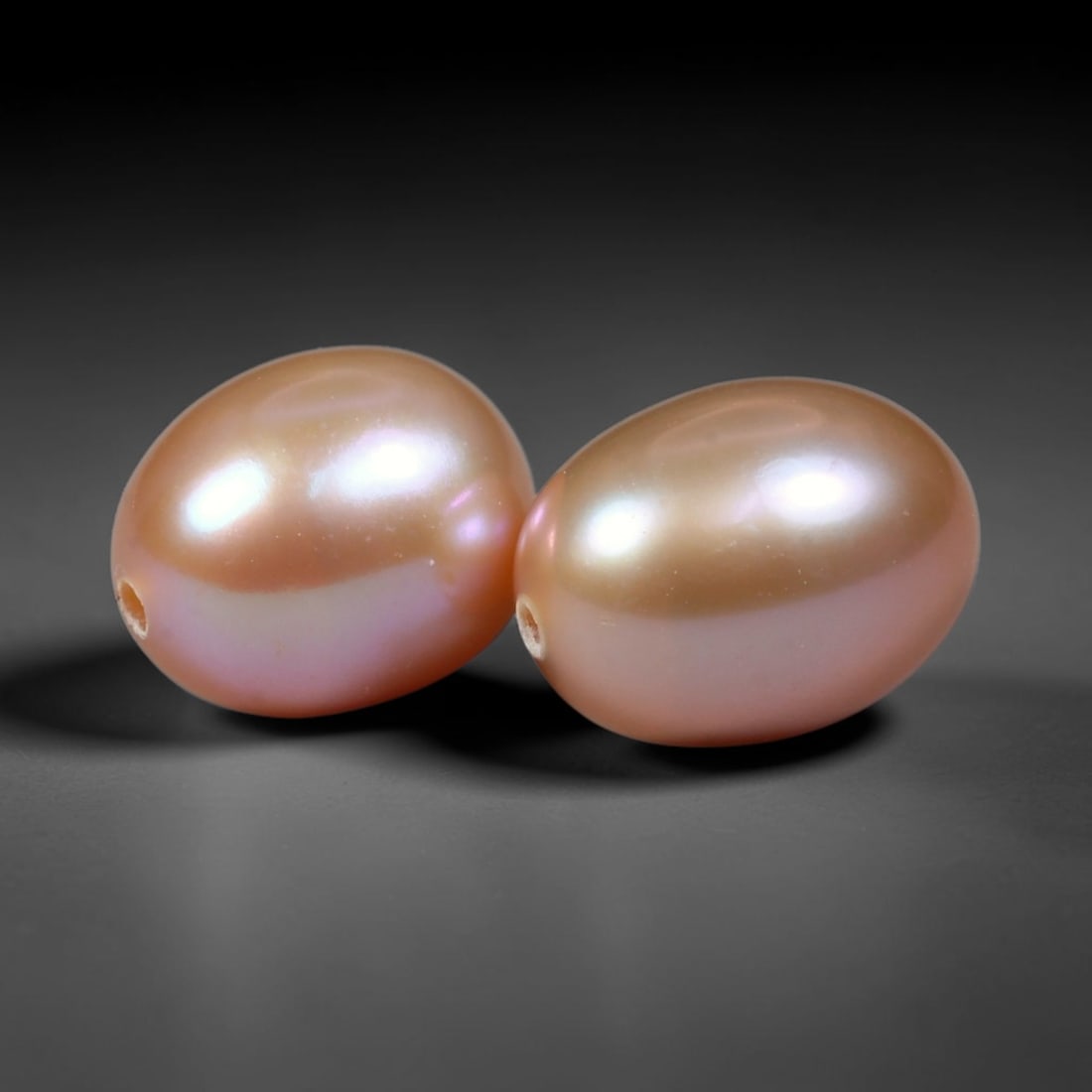 6.80ct Natural Soft Mauve Pink Orient Freshwater Egg Shape Pearl Pair, 68XZ: Matching pair of natural freshwater egg/oval pearls, uniform dimensions 9.6x7.2mm with neat fully drilled through holes ready for immediate jewelry assembly. Each pearl boasts a smooth satiny nacre su