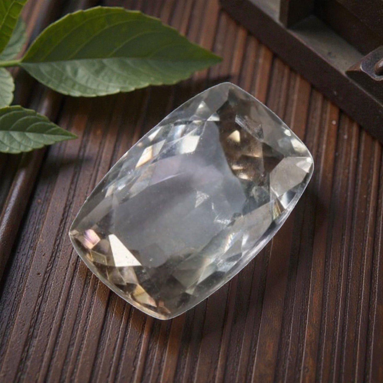 2.06 Carats Grayish-Blue Tanzanite Cushion - Natural Tanzanian Stone, 57XK: This single cushion-cut tanzanite exhibits a soft, misty grayish-blue hue, accented by subtle warm undertones that add depth to its color profile. The faceted cut creates gentle light play across the 