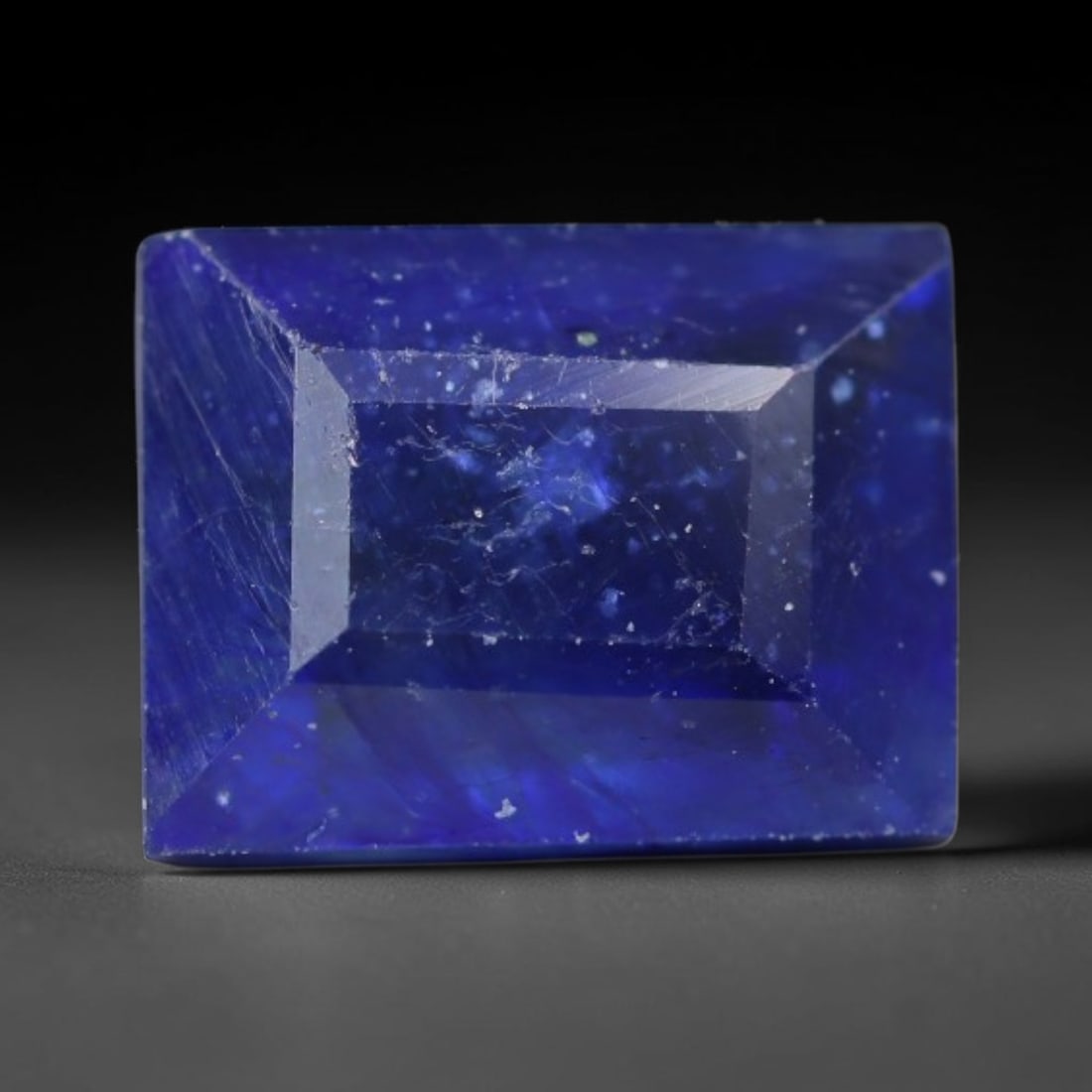2.14 Carats Royal Blue Sapphire Emerald Cut Loose Gemstone, 43WS: This sharp emerald rectangular faceted sapphire features an intense deep royal blue hue, brought to vivid life by crisp step-cut facets. Natural fine fissures and scattered tiny mineral micro-inclusio