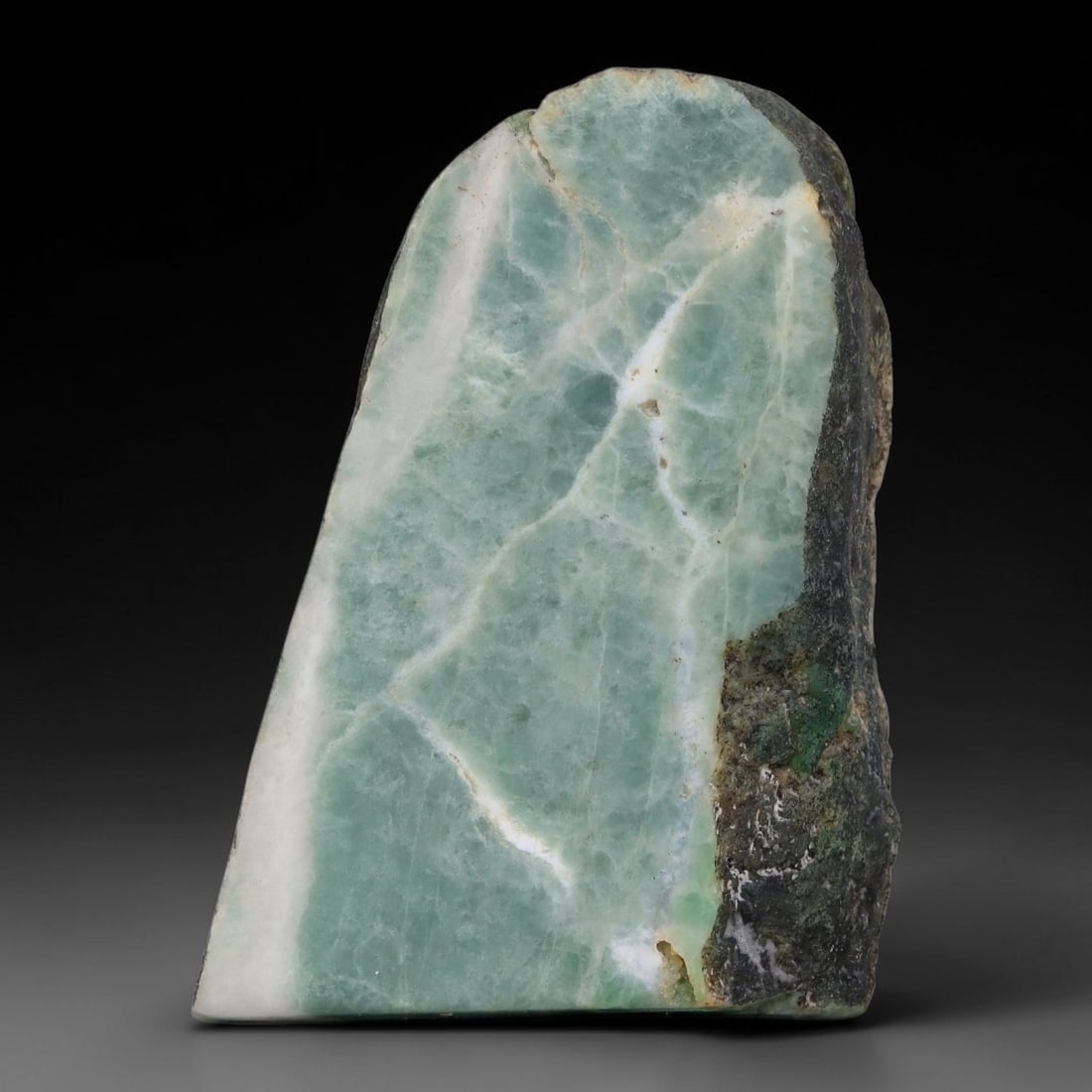 197ct Natural Type A Burmese Jadeite Jade Sliced Rough, 10YN: This specimen is a sliced rough block of natural Type A Burmese jadeite jade. The interior displays natural colour zoning with visible mineral veining and crystalline patterns typical of unprocessed j