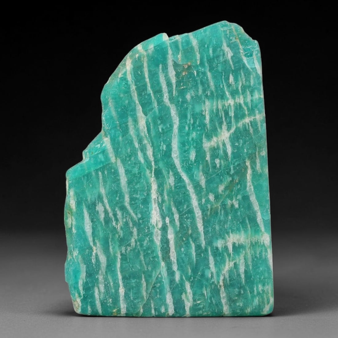 65ct Natural Russian Ural Amazonite Slab Rough, 15WV: This intact amazonite slab features distinct parallel mineral banding running uniformly across its naturally split flat surface within 42x30x5mm slab dimensions, retaining unmodified natural geologica