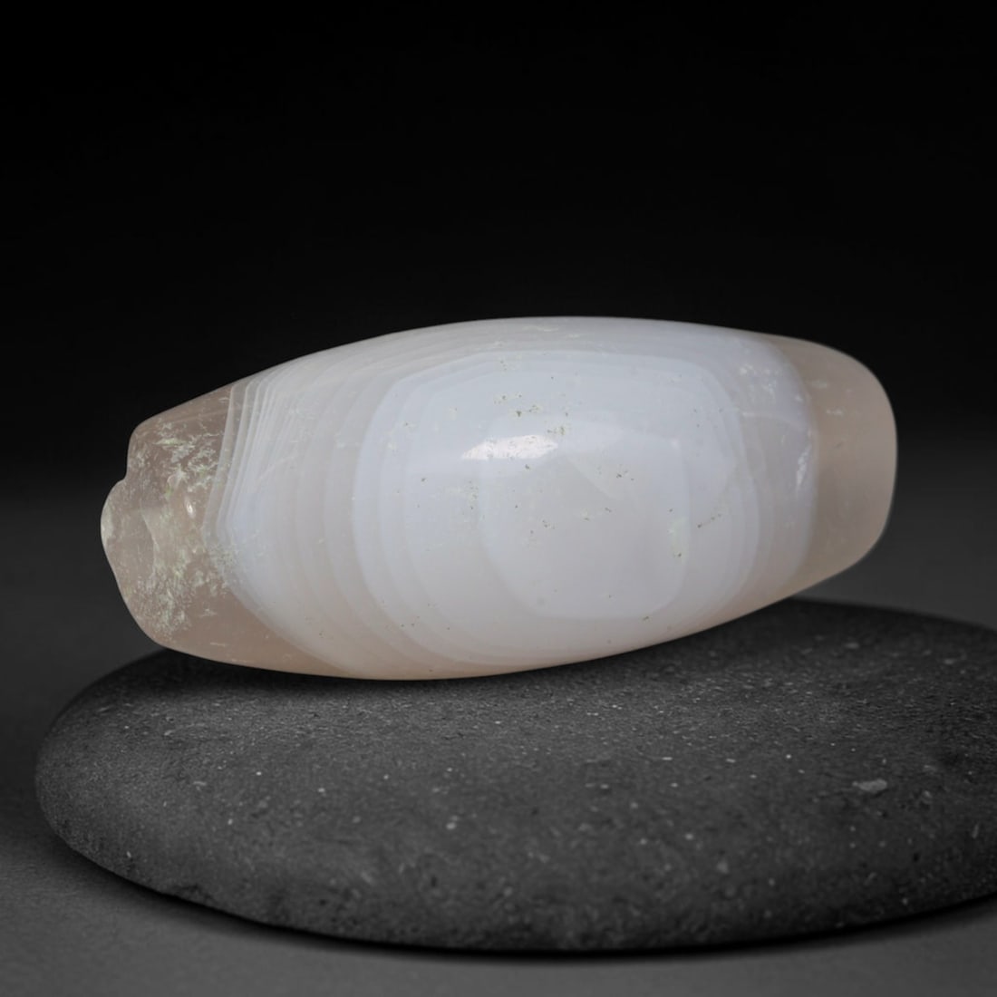 Ancient Medieval Qarakhanid Turkic Culture Banded Agate Bicone Bead (840-1212 CE), 90XD: This antique banded agate bicone bead originates from Qarakhanid Turkic Culture, medieval Central Asian caravan hub artisans who produced uniform layered agate trade beads for Persian and Chinese mark