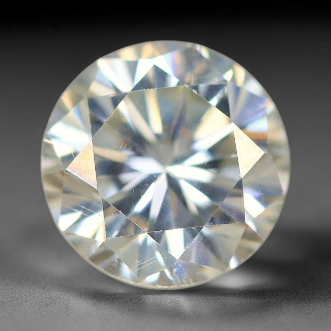 3.82 Carats Clear Moissanite Loose Gemstone, 82WP: This moissanite features dimensional measurements of 10x6.3mm, a lab-created silicon carbide gem material celebrated for an impressive refractive index that creates intense light dispersion and dynami