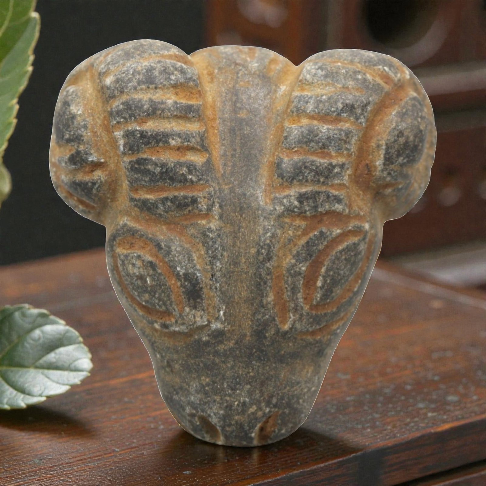 Ancient Stone Ram Head Amulet - Near Eastern Zoomorphic Protective Figurine, 5ZR: This artifact is a carved stone ram head amulet, executed in the stylized zoomorphic tradition of the ancient Near East. The amulet depicts a compact ram head with prominent curved horns incised with 