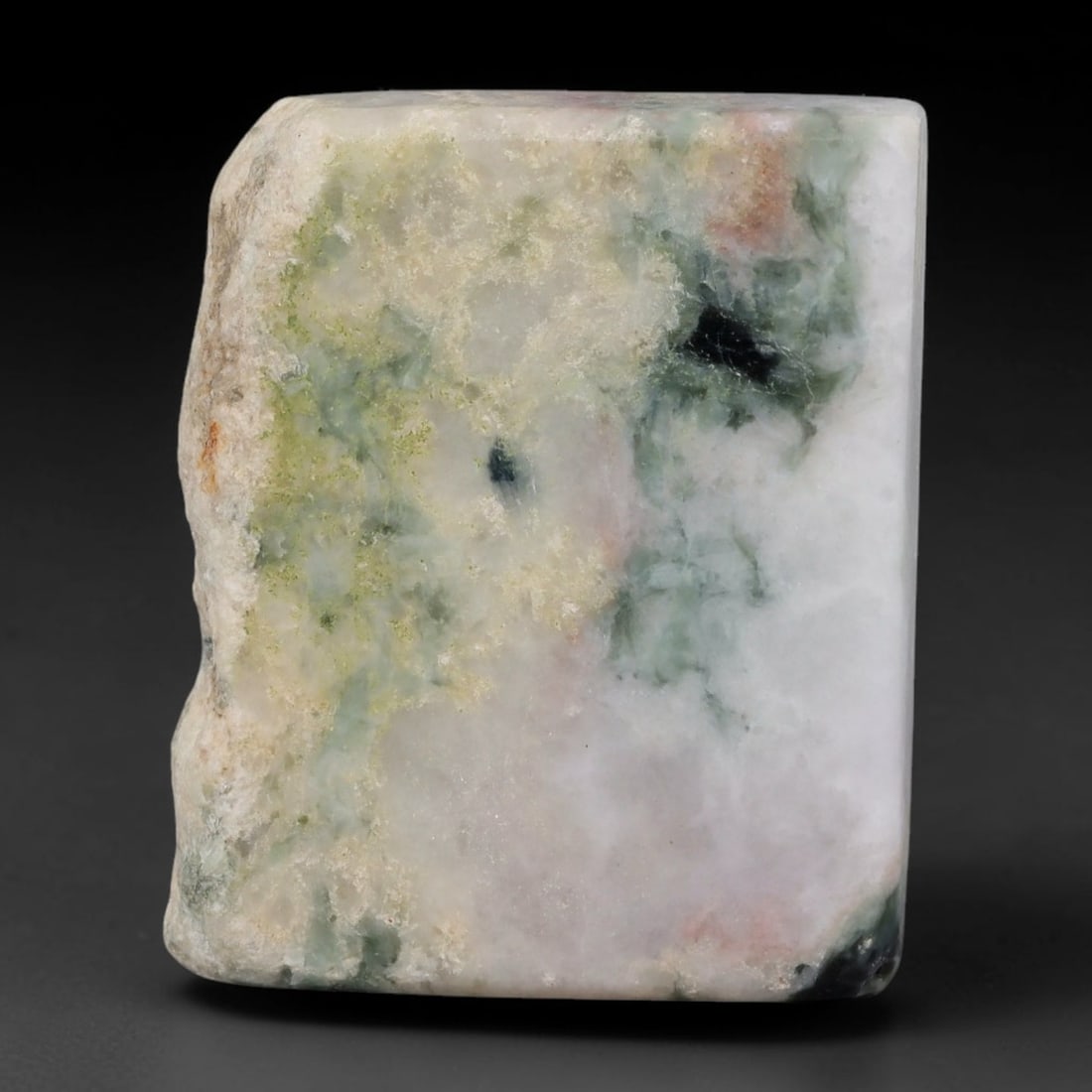 285ct Natural Type A Burmese Jadeite Jade Sliced Rough, 14YR: This specimen is a sliced rough block of natural Type A Burmese jadeite jade. The interior displays natural colour zoning with visible mineral veining and crystalline patterns typical of unprocessed j