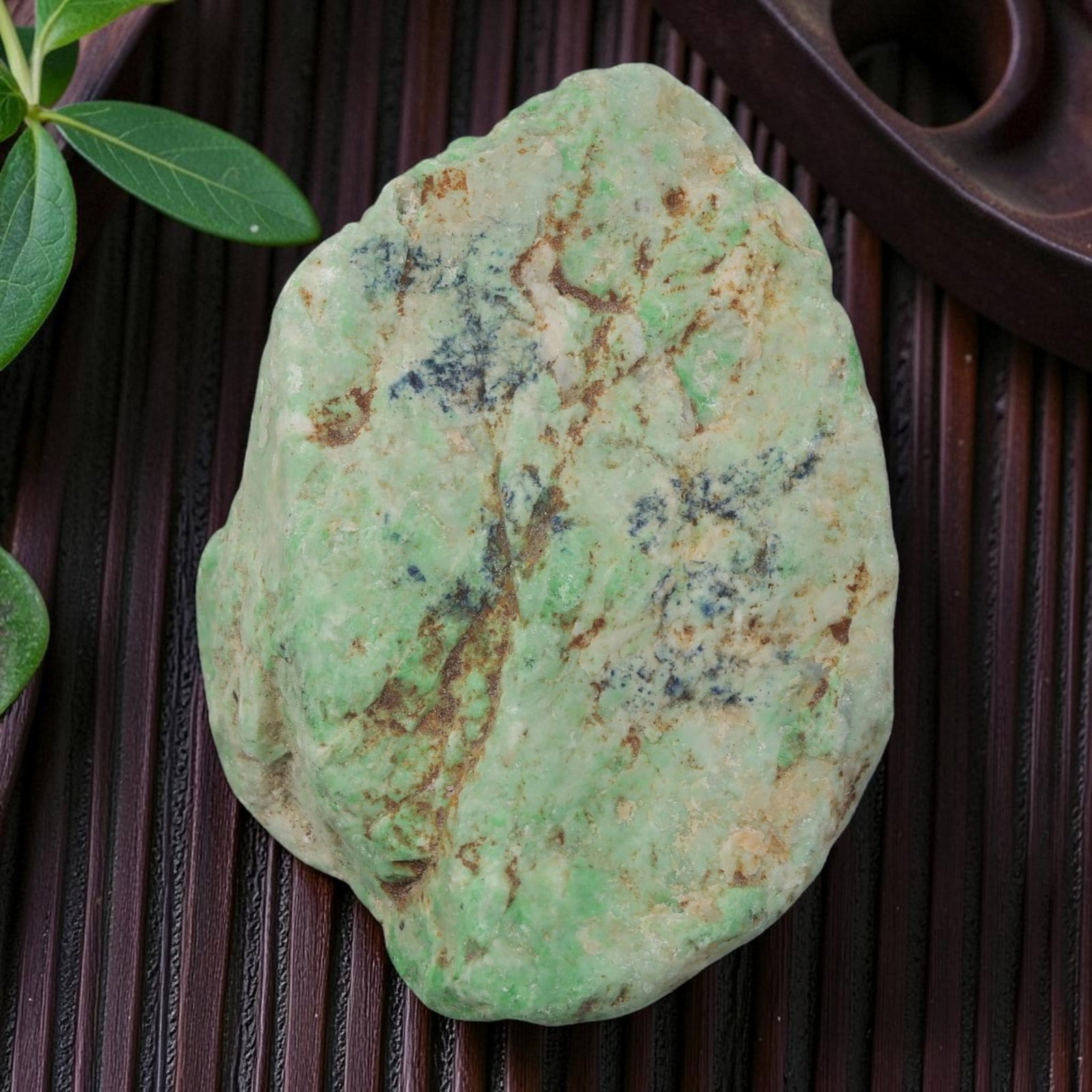 265Ct Natural Type A Burmese Jadeite Jade Rough Stone - Green Raw Material, 12ZB: Natural Type A Burmese jadeite rough stone, displaying vibrant mottled green inclusions across a pale translucent base, with natural brown weathered skin visible along the edges. The stone retains its