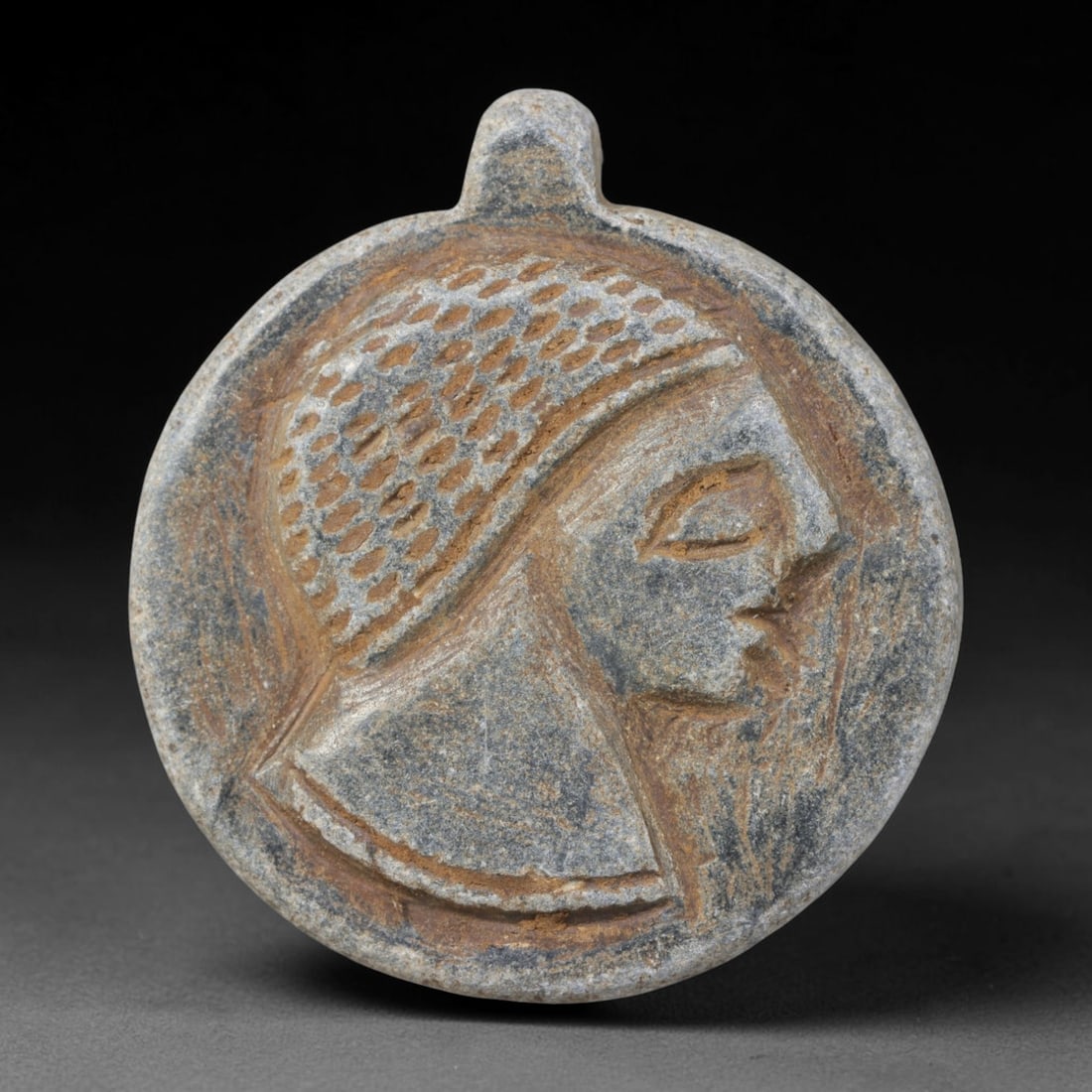 Ancient Near Eastern Hand Carved Schist Protective Amulet, 46WT: Compact antique wearable sacred talisman hand hewn from natural speckled schist metamorphic stone, originating from the broad cultural sphere of the Ancient Near East. Schist was a staple carving mine