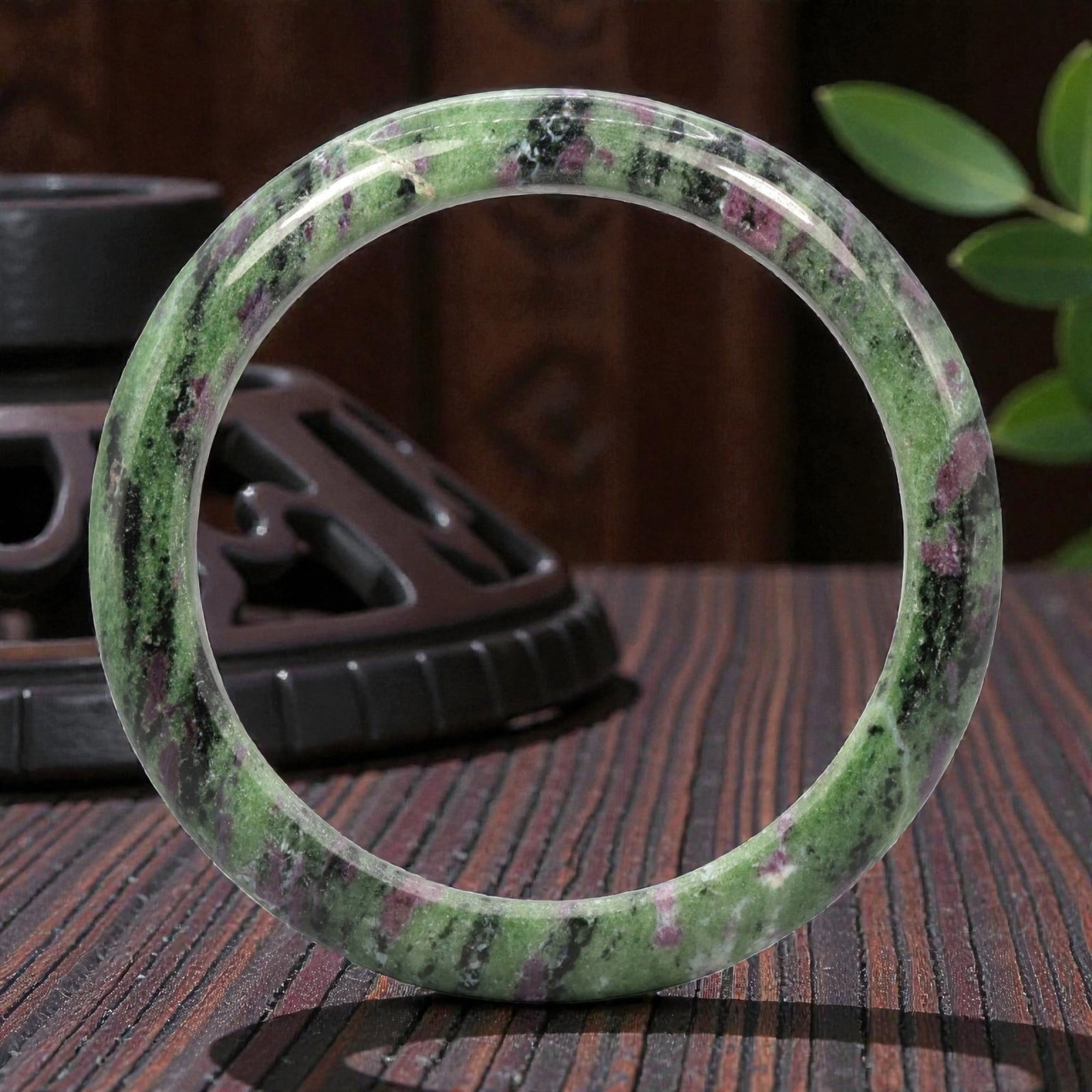 Natural Bi-Color Ruby Zoisite Bangle, 1ZK: Carved from ruby zoisite, this bangle is formed as a continuous circular band with a rounded, slightly thickened profile. The material exhibits a vibrant green zoisite matrix, with distinct black incl