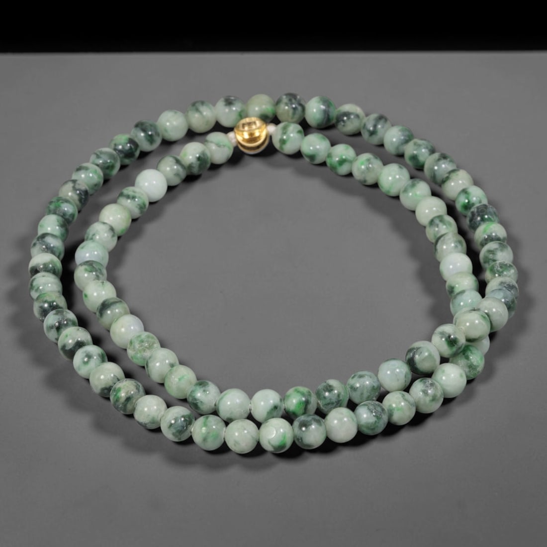 Natural Burmese Type A Pale Floating Jadeite Jade Beaded Necklace, 14WY: Constructed from unprocessed Burmese Type A jadeite stone, each spherical bead displays soft scattered green mineral flecks naturally integrated into the pale stone matrix through geological formation