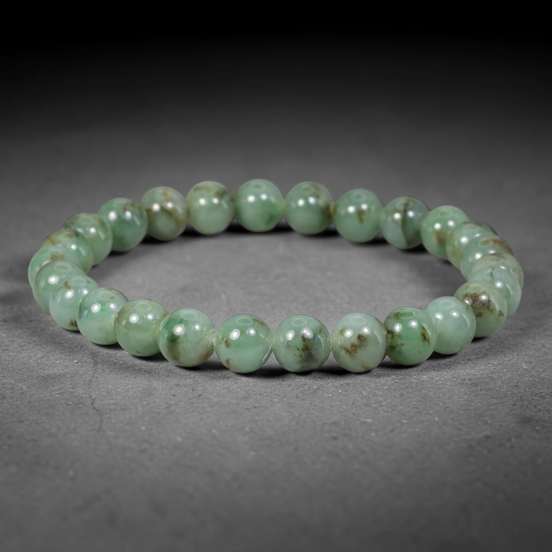 Natural Burmese Type A Green Floating Jadeite Jade Beaded Bracelet, 39WY: Formed from natural untreated Burmese Type A jadeite material, each spherical bead bears naturally dispersed green mineral markings embedded within the stone matrix through geological formation proces