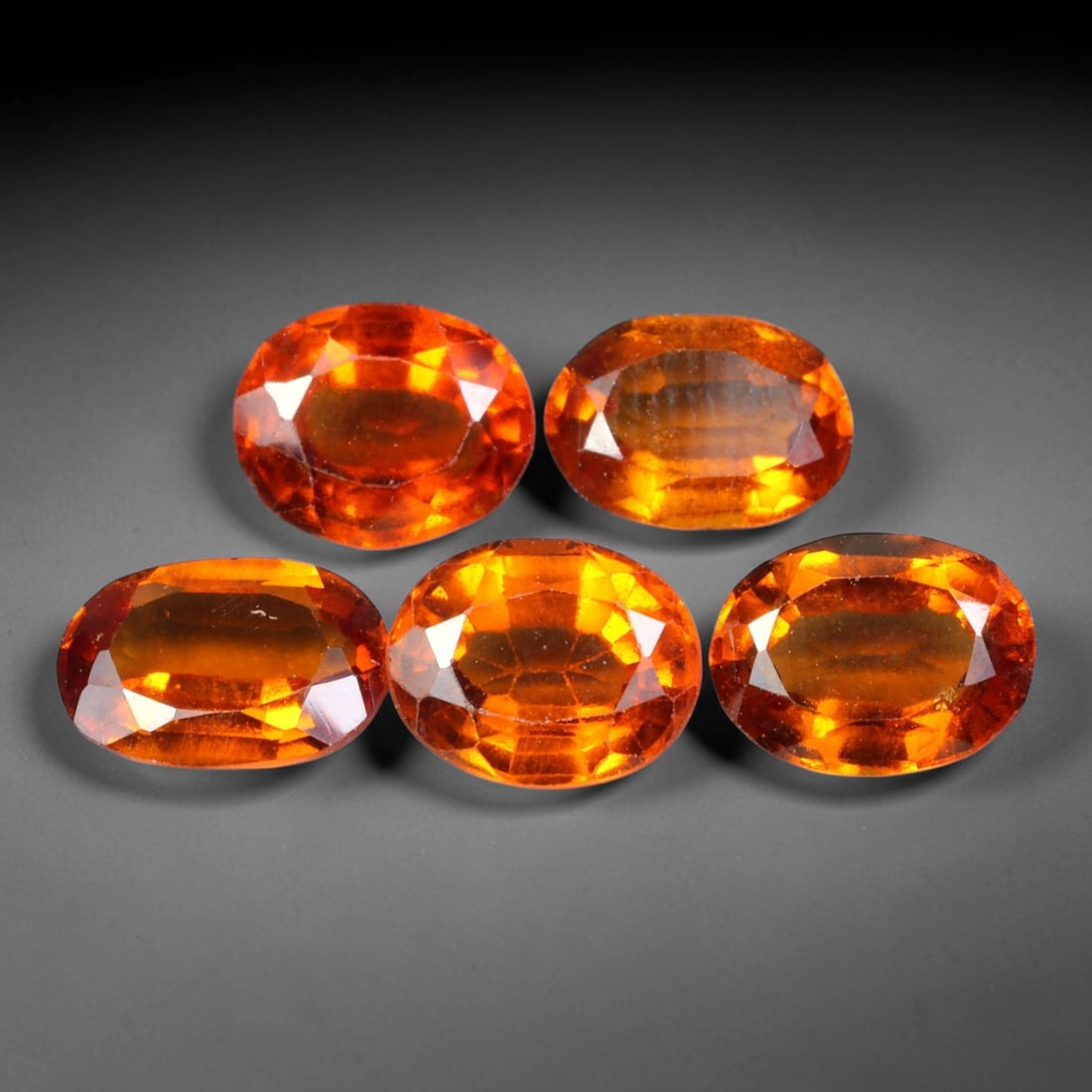 7.80ct Natural Hessonite Garnet Oval Faceted Parcel Loose Gemstone, 95XX: Matching parcel of hand faceted natural hessonite garnet gemstones featuring rich warm orange-brown hue with subtle inherent mineral characteristics within each stone. Precision faceting and glossy hi