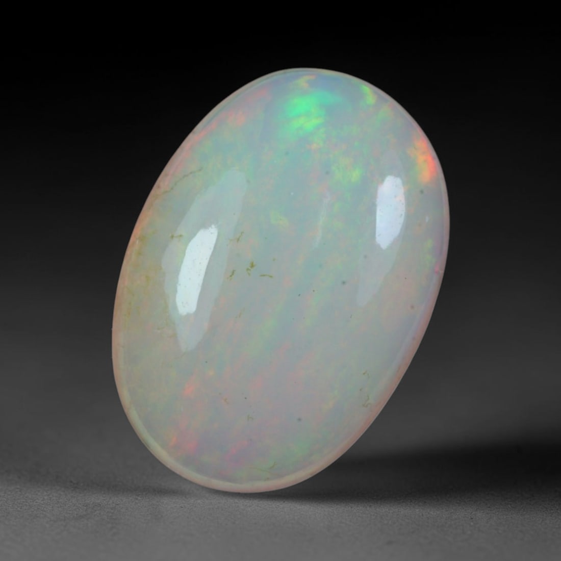 3.85 Carats Natural Ethiopian Welo Opal Oval Cabochon Loose Gemstone, 58XV: Natural Ethiopian Welo opal polished oval cabochon loose gemstone, luminous translucent milky white base stone with vivid multi-hued play-of-color featuring bright emerald green, lime yellow, soft blu