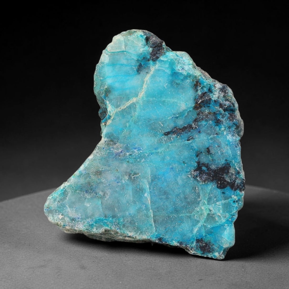 148ct Natural Peruvian Chrysocolla Polished Slab Rough, 42WV: This partial-polished chrysocolla slab features blended mineral matrix with smooth refined face and unaltered natural rugged edge across its 33x26x22mm elongated form, translucent mineral layers hold 