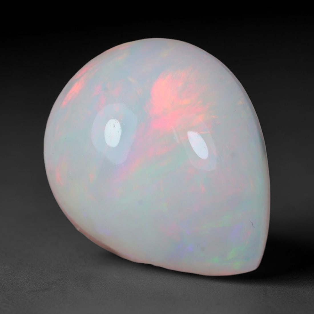 3.98 Carats Natural Ethiopian Welo Opal Oval Cabochon Loose Gemstone, 36XV: Natural Ethiopian Welo opal polished oval cabochon loose gemstone, luminous translucent milky white base stone with vivid multi-hued play-of-color featuring bright emerald green, lime yellow, soft blu