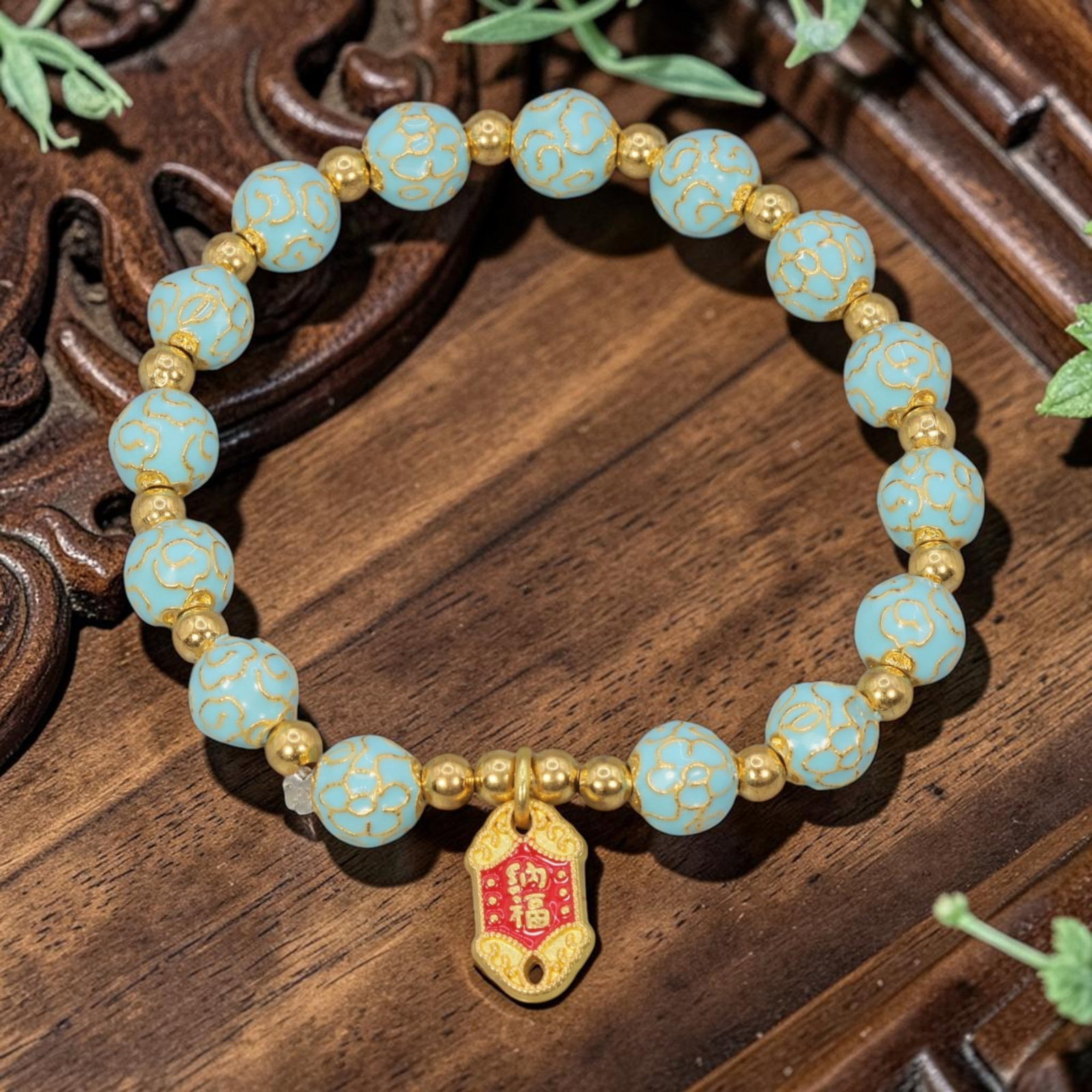 A Chinese Cloisonne Enamel Beaded Bracelet - Light Blue Gold-Tone "Blessings" Charm, 59YJ: This modern Chinese-style bracelet features 7.86mm round cloisonne enamel beads in a soft light blue hue, each detailed with raised gold-tone cloud patterns. Small smooth gold-tone spacer beads separa