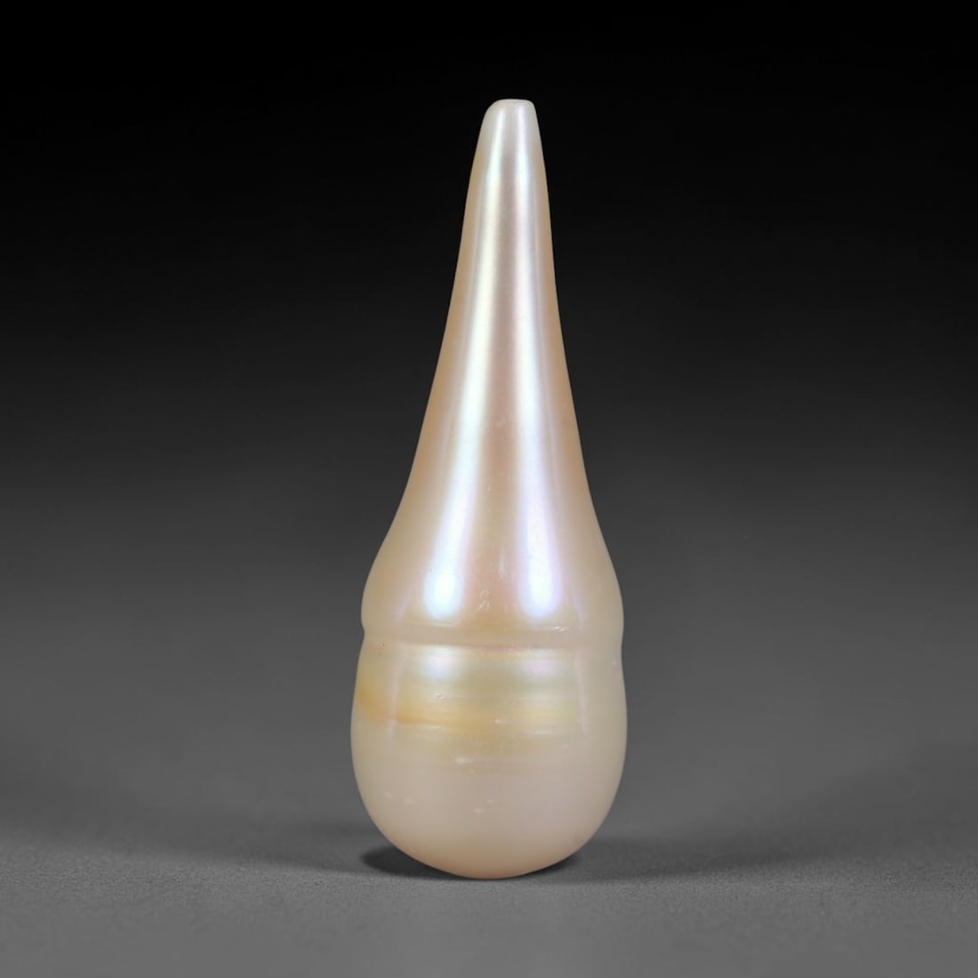 Natural Freshwater Baroque Pearl - Cream Champagne Teardrop Form, 62WE: This natural freshwater baroque pearl features an elongated organic silhouette wrapped in smooth glossy iridescent nacre with soft cream and pale champagne shifting overtones across its polished surfa